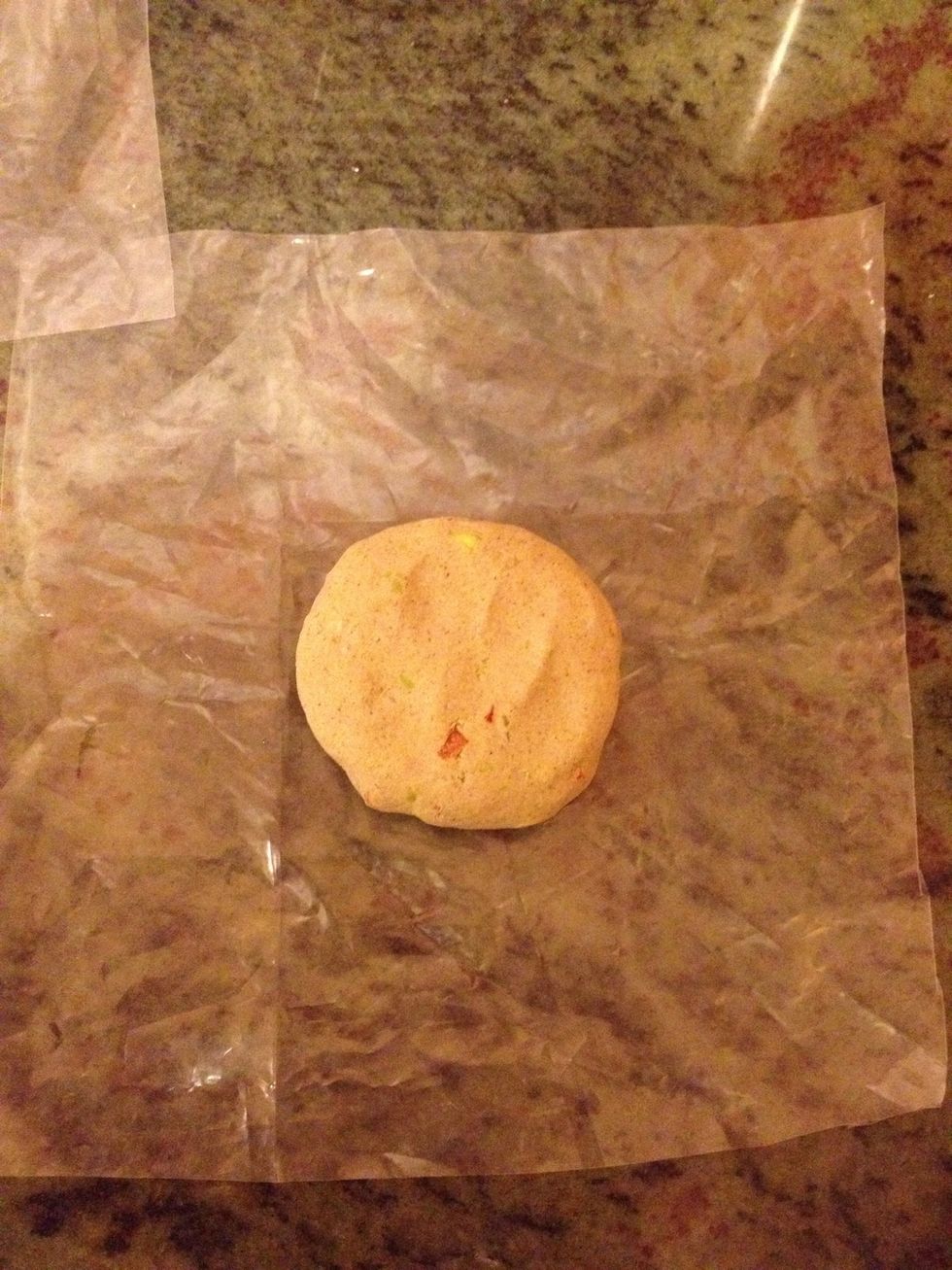 Take butter paper or u can take a hard plastic cut into 2 squares an put the rounded dough between the paper .