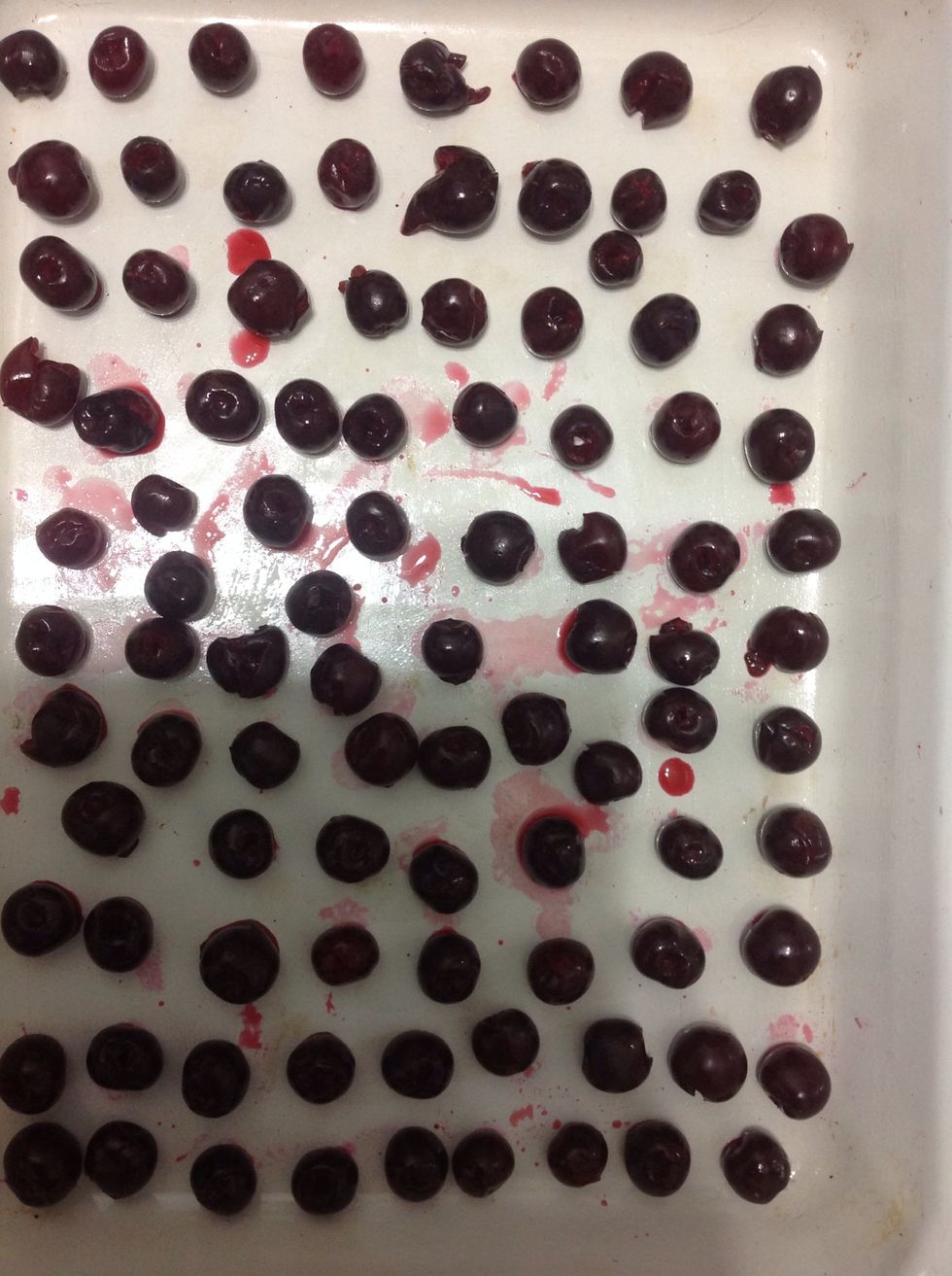 Take cherry seeds out and put them on a baking tray
