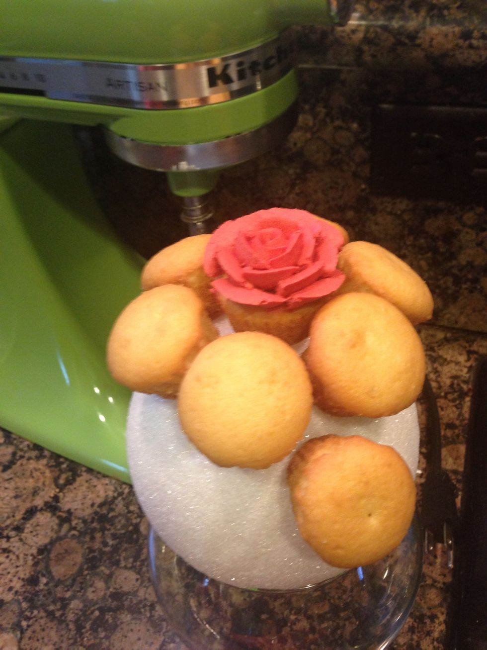 Take cupcake out and pipe rose frosting and then reattach on the ball