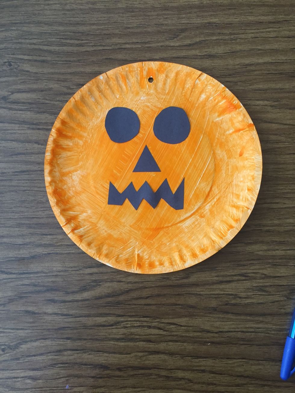 Take Elmer's glue and stick each cut out piece into the correct spots on the pumpkin.