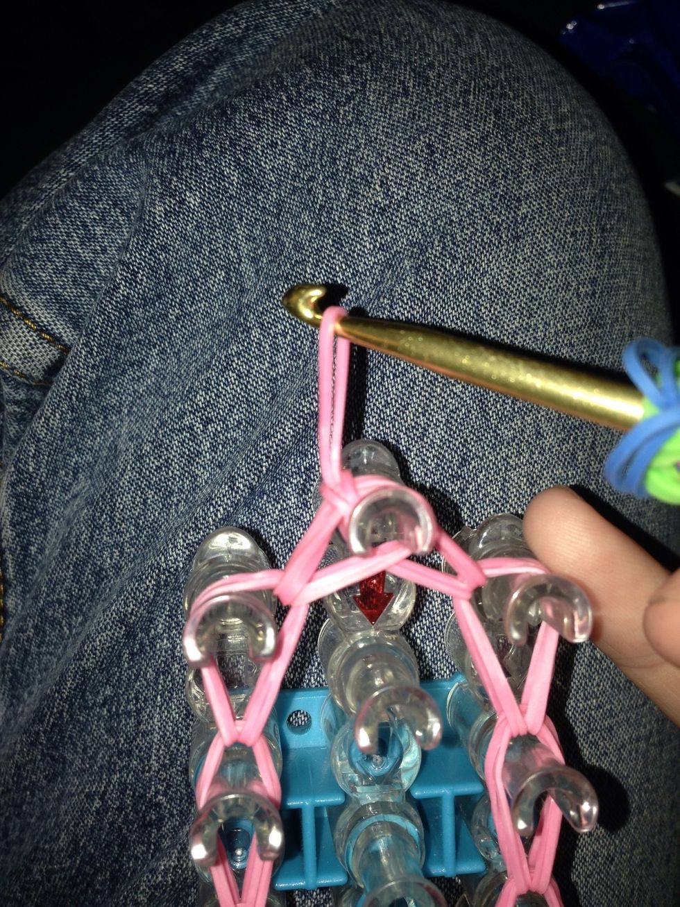 Take end that is closet to the hook and pull it through the other end. Pull tight. This will create a slip knot and will hold all the bands in place. Now it's time to pull your charm off the loom.