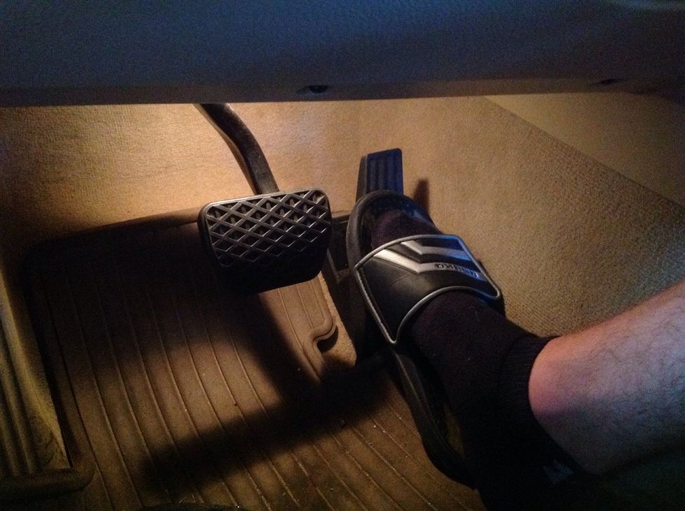 Take foot off brake and slowly press accelerator to gain speed