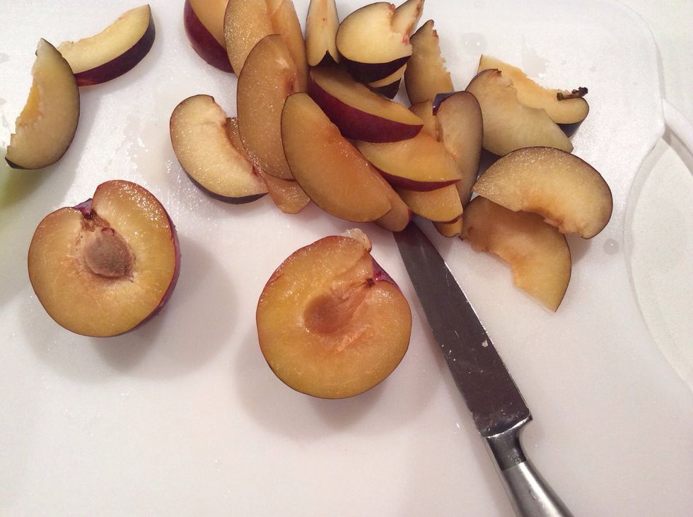 Take four or five plums and slice them into evenly sized wedges