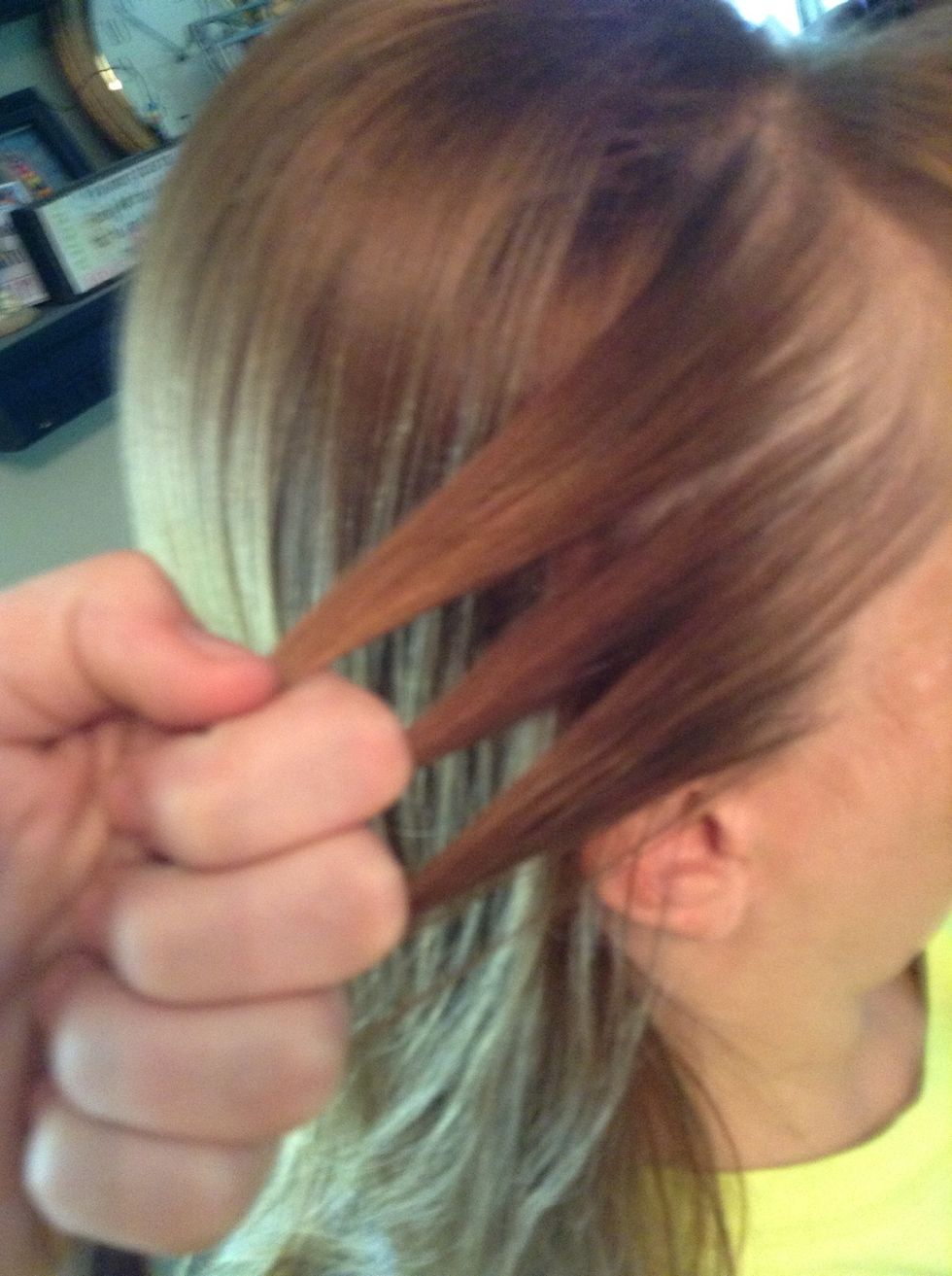 Take hair from one side and split it into three strands