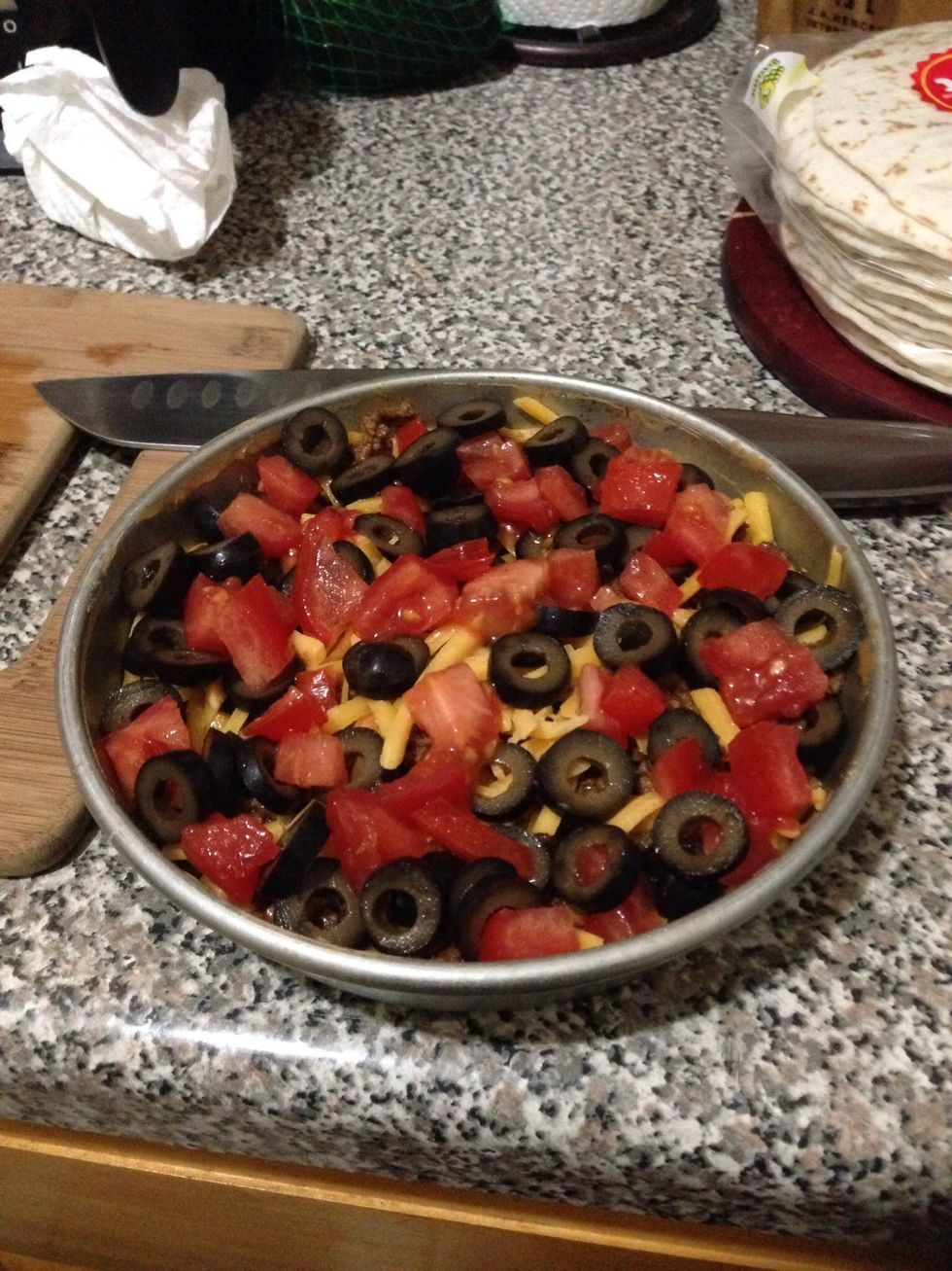Take half of your olives and tomatoes and layer it on top. You can add more or less to your liking. Just remember to save a little more to garnish your dip once it's ready.