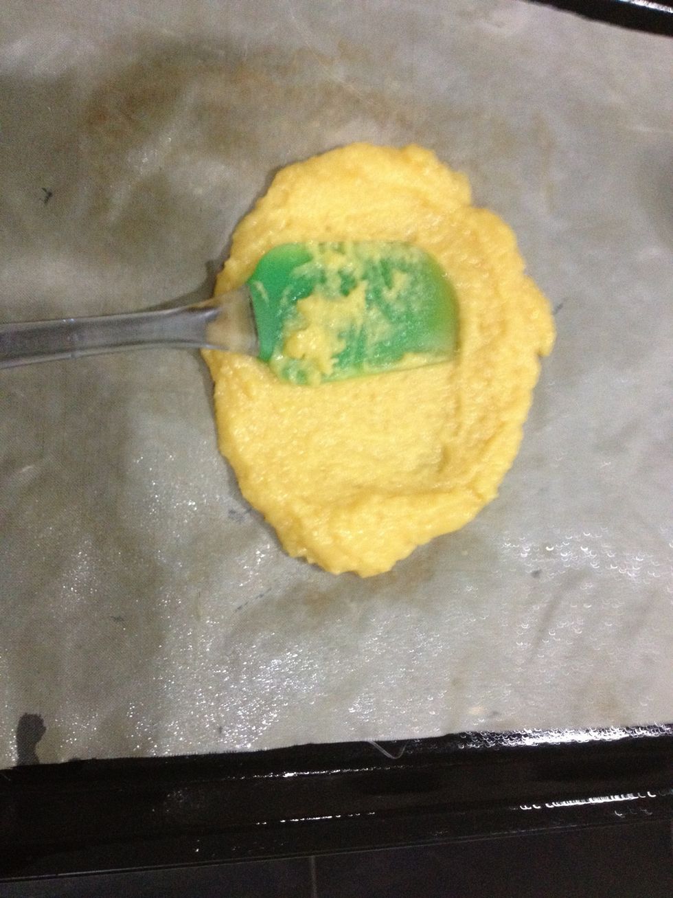 Take half the mixture and place it in a generously greased parchment paper lined baking sheet. I used my reusable baking cloth. Even it out to your desired shape and bake for 12-15 mins.