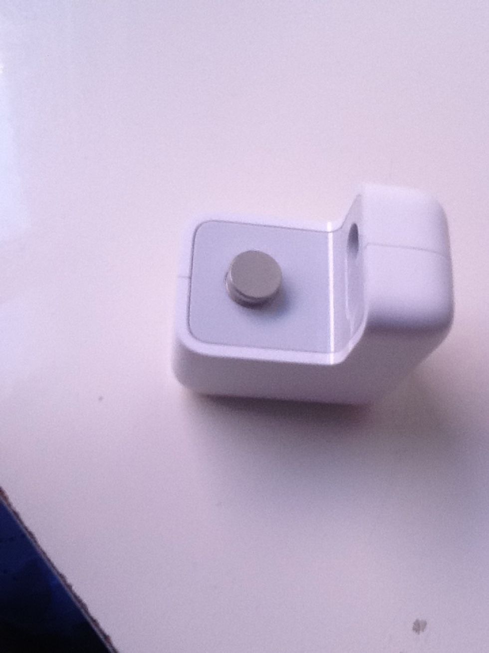 Take it. Align the cap/top of the beer so that the circle piece will be whats going to slide under the cap.