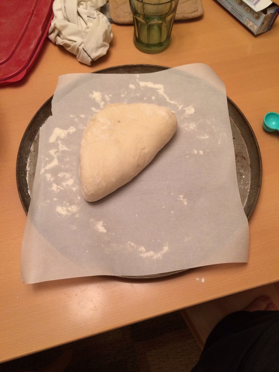 Take it out of the bowl. Dropping it on floured parchment paper then folding it twice. Form it into a ball. This is a picture of it folded. Already lightly floured on both sides