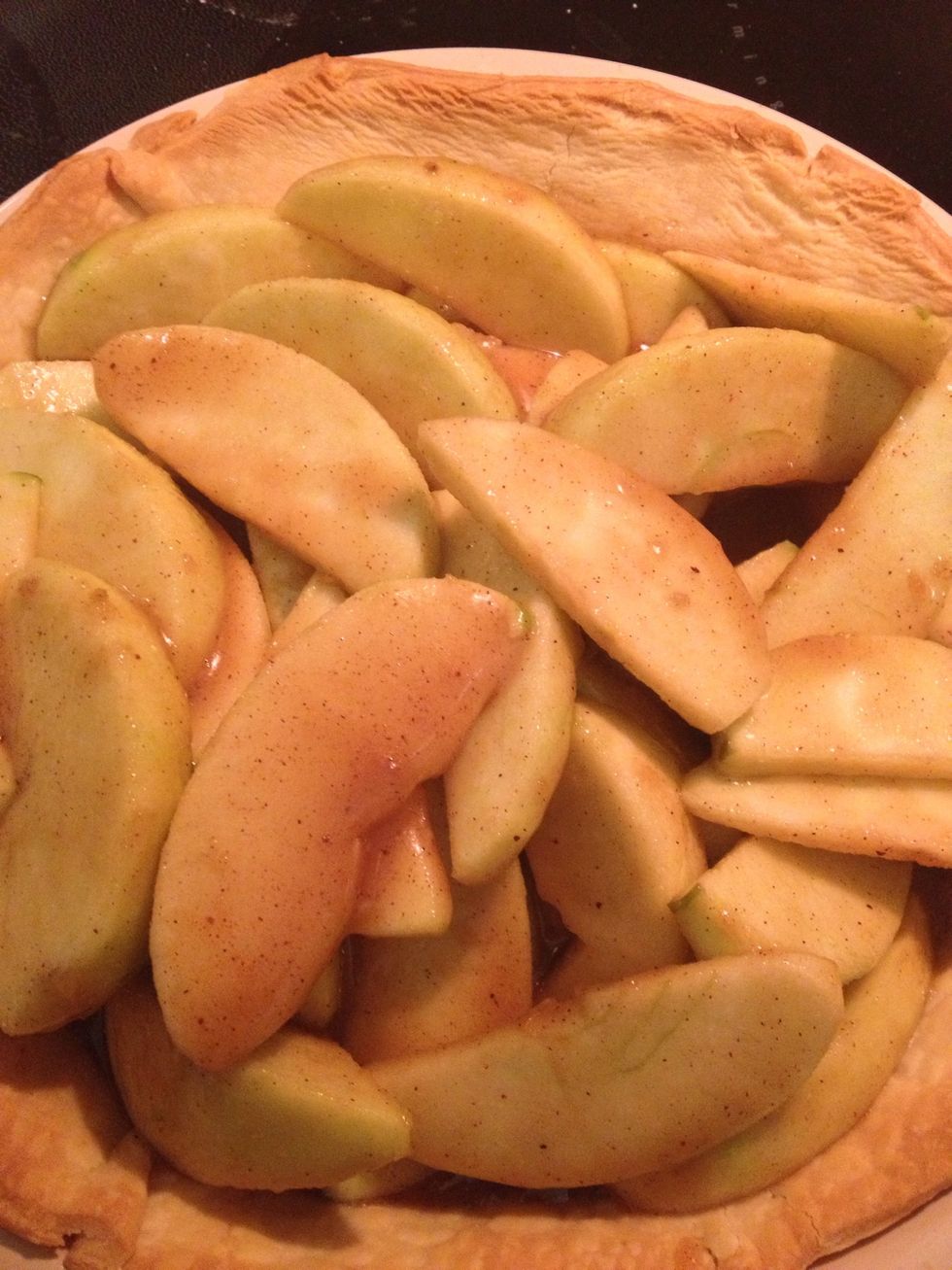 Take it out of the oven and add your apples to the baking dish.