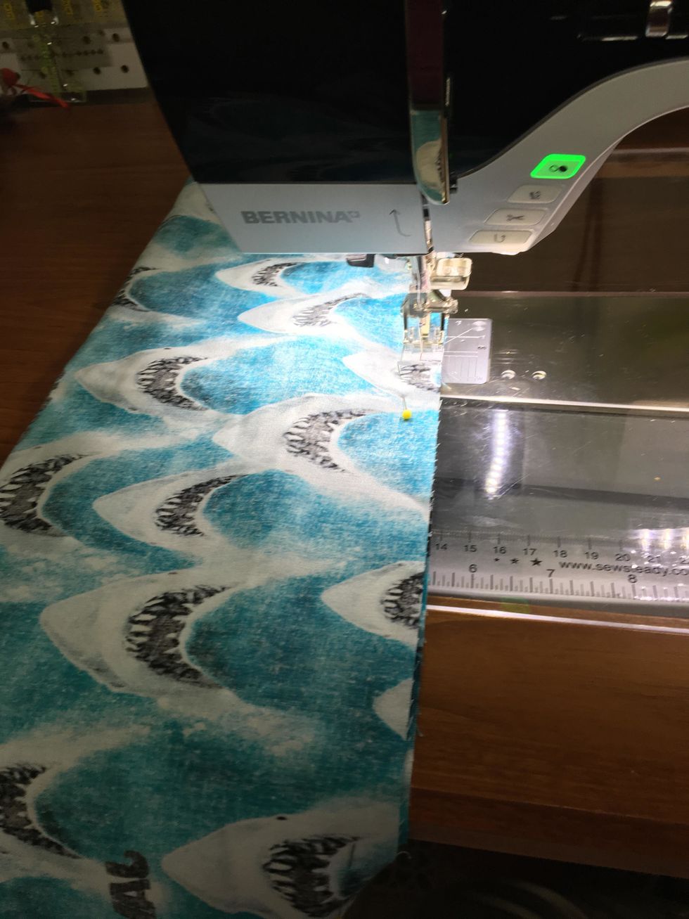 Take it to the sewing machine, sew the long pinned edge together, 3/8 inch seam allowance will work fine. You want to make sure you catch the body fabric in the seam.