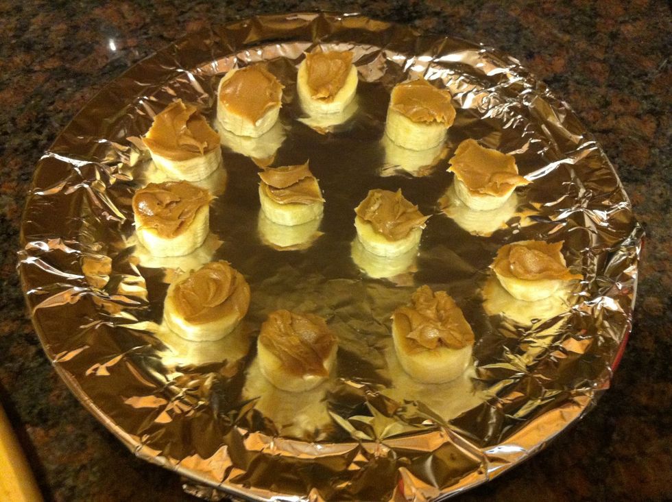 Take knife and apply peanut butter to the top of every slice. You can use as much or as little as you want.