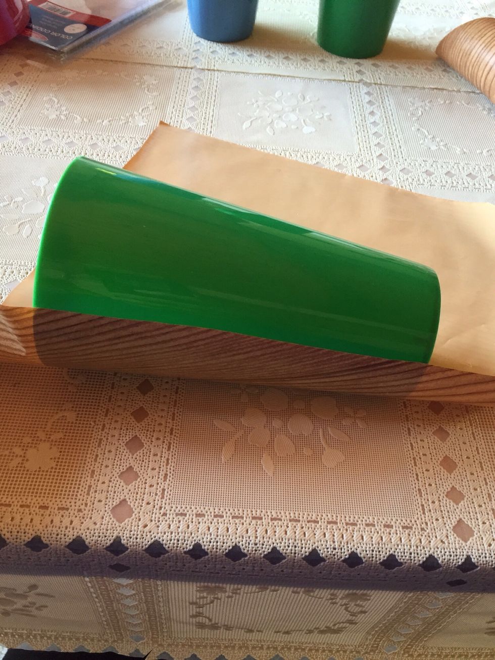 Take off backing from contact paper, lay mug down and roll paper tightly to cover cup.