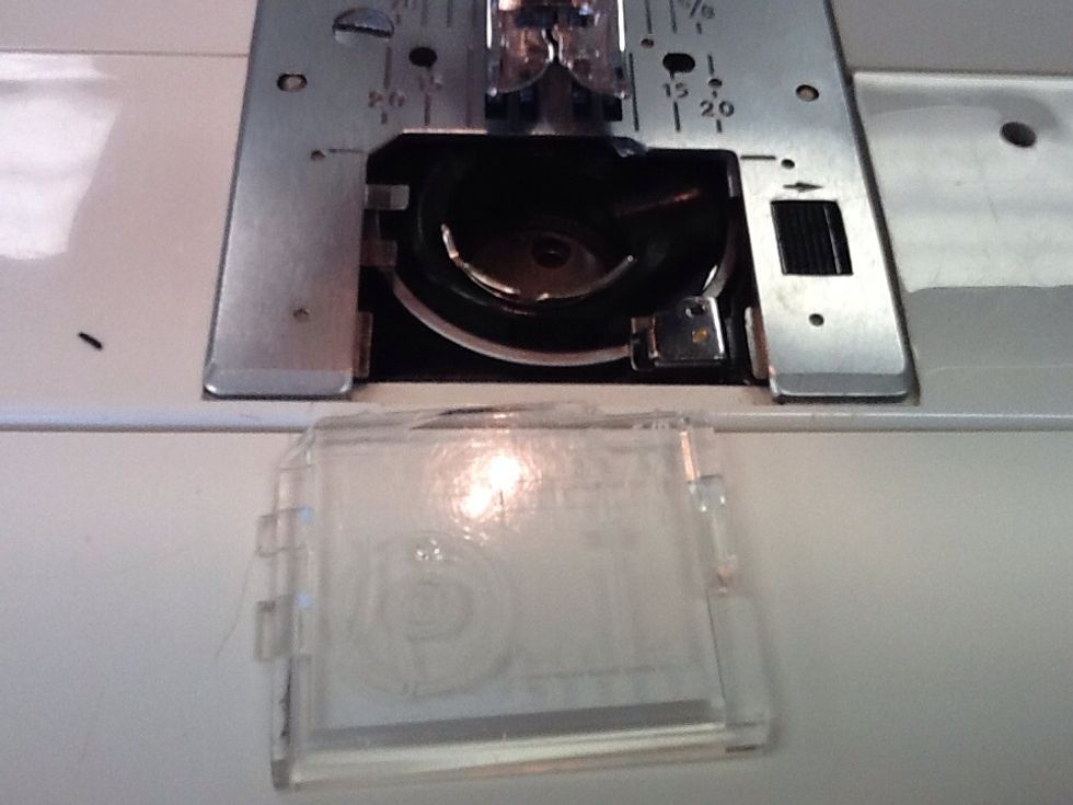 Take off bobbin cover.