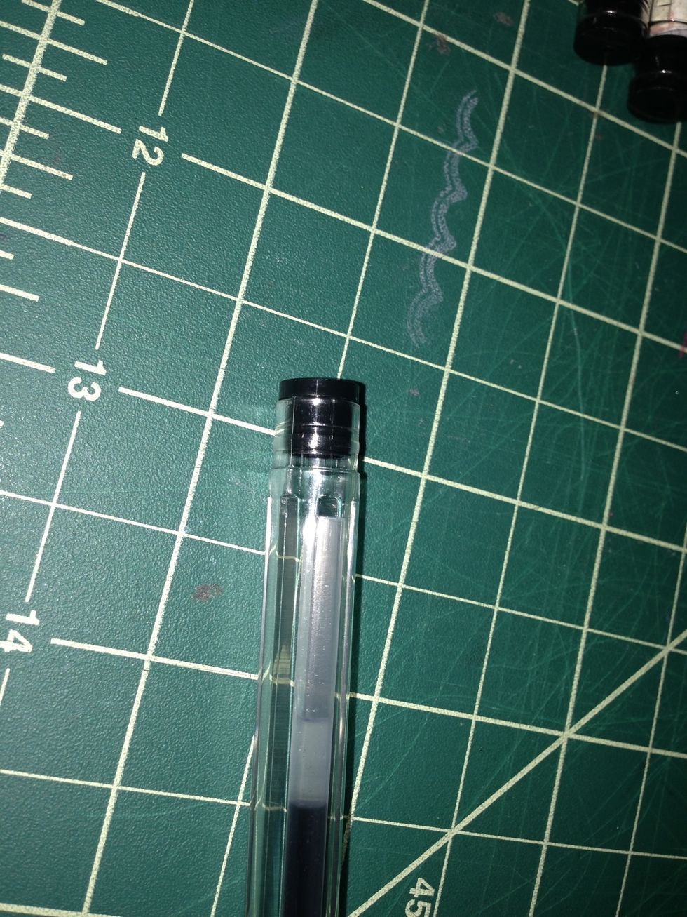 Take off end cap on pen. If you have retractable pens you may need to take it fully apart to put the paper in.