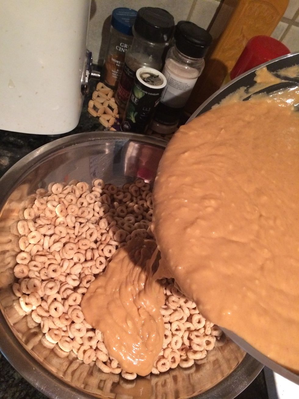 Take off heat and let cool for 3 mins and then pour over Cheerios in a mixing bowl