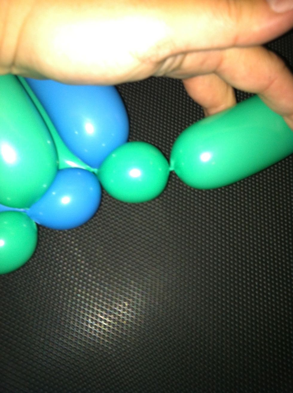 Take off the excess at ends by twisting off a bubble, and then cutting the balloon at the end to release excess air, and tying off