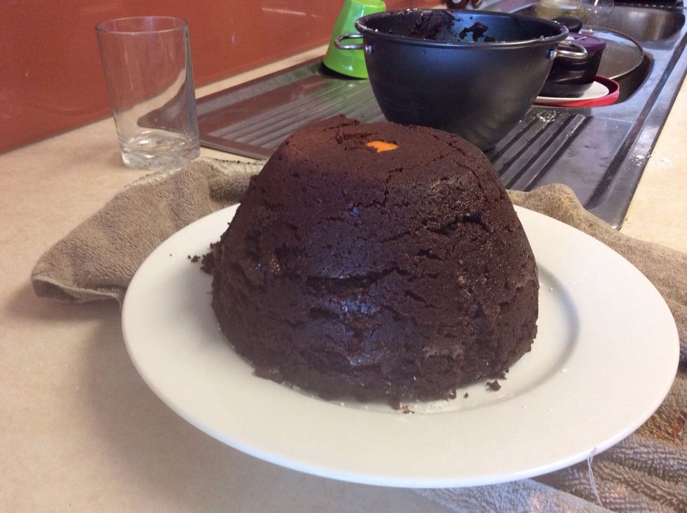 Take off the lid and slowly lift the basin to reveal the finished pudding.