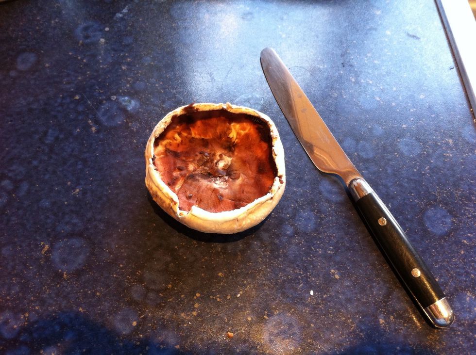 Take off the stalk of the mushroom and remove the brown inside with a butter knife (be careful not to break the mushroom)