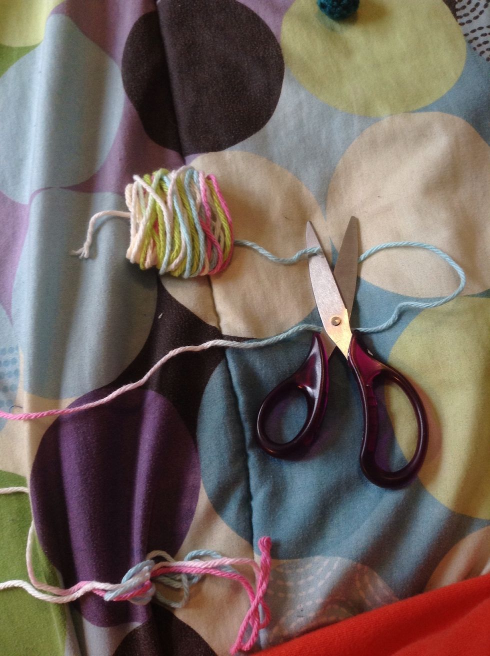 Take off your hand carefully and cut yarn leaving a little extra to use