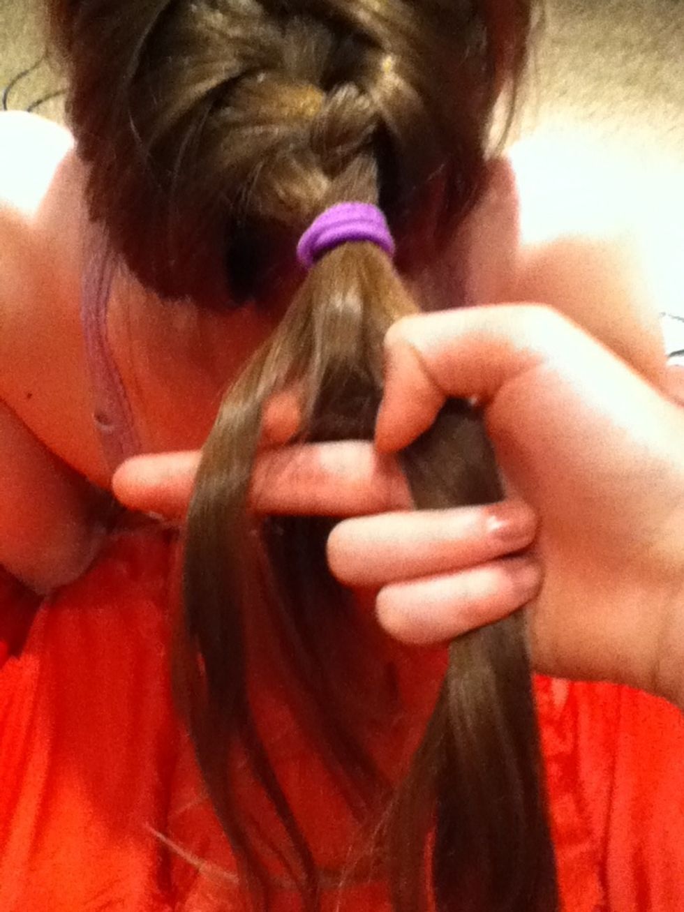 Take on small piece of hair from the end of one side.