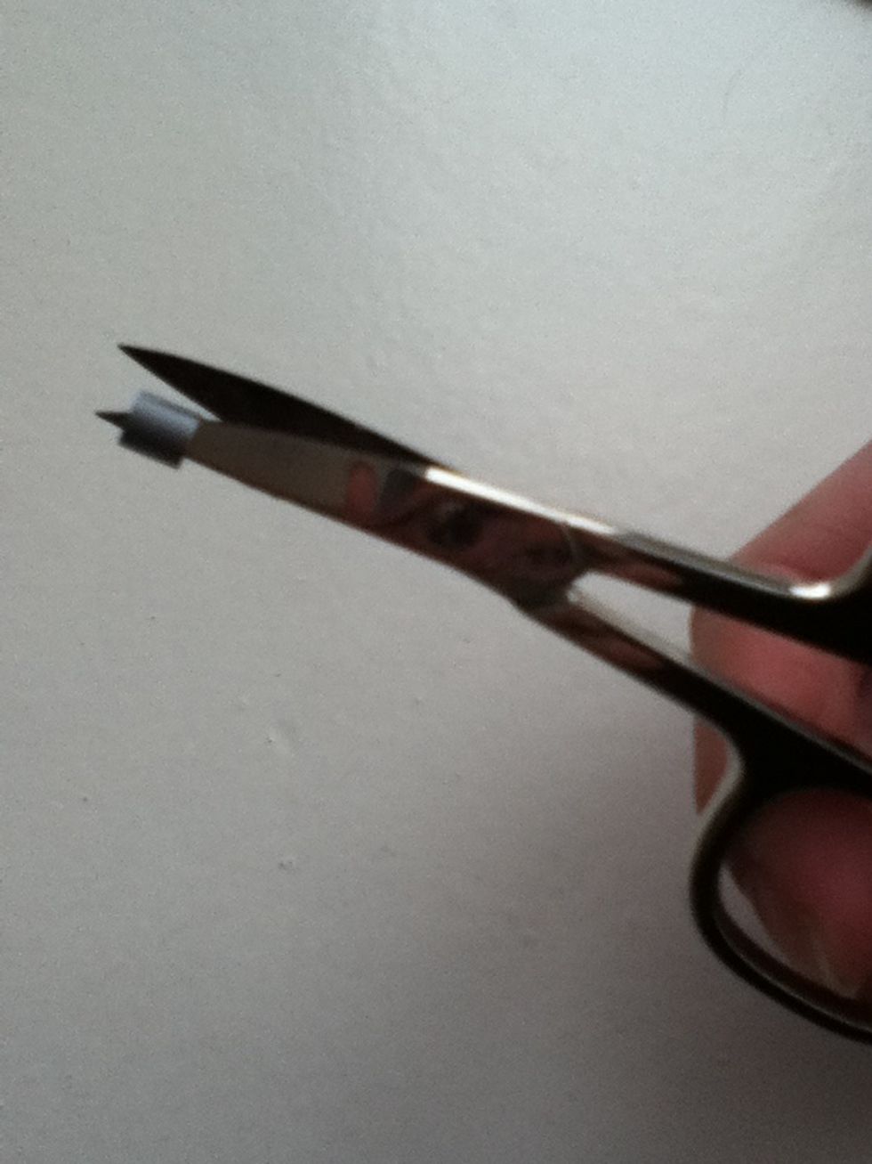 Take one bead and cut it open with your scissor.