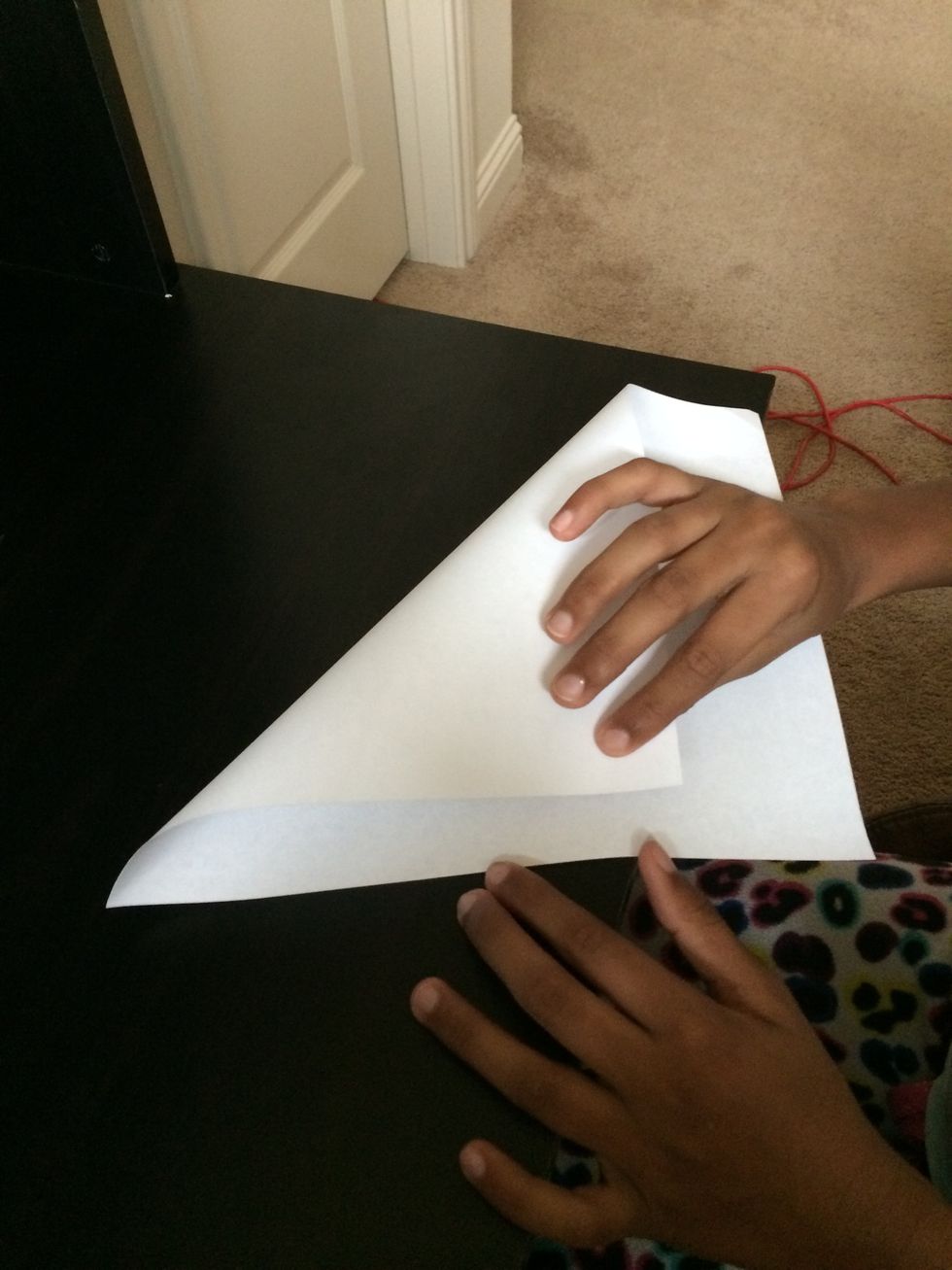 Take one corner of your paper and fold it to make it look like a triangle.