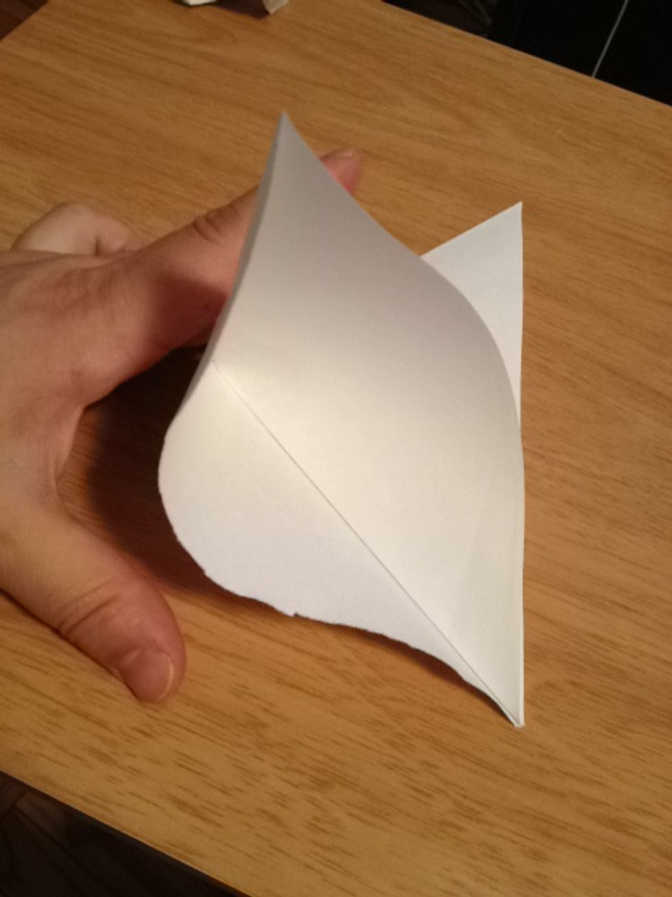 Take one corner, open it up and fold it down.
