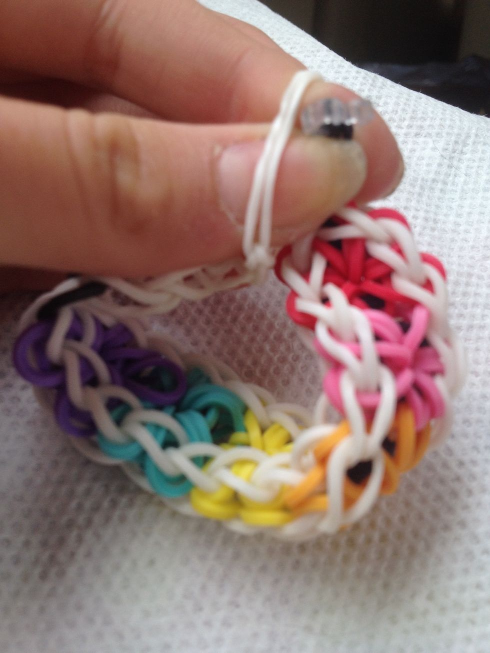 Take one end of the bracelet and clip it to the other end.