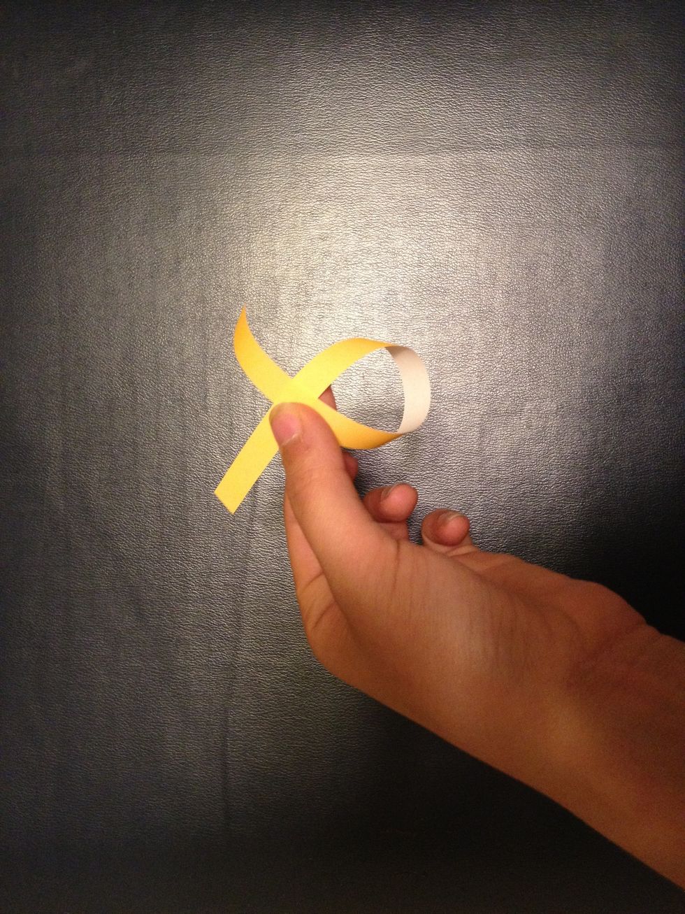 Take one end of the strip and put it over the other.