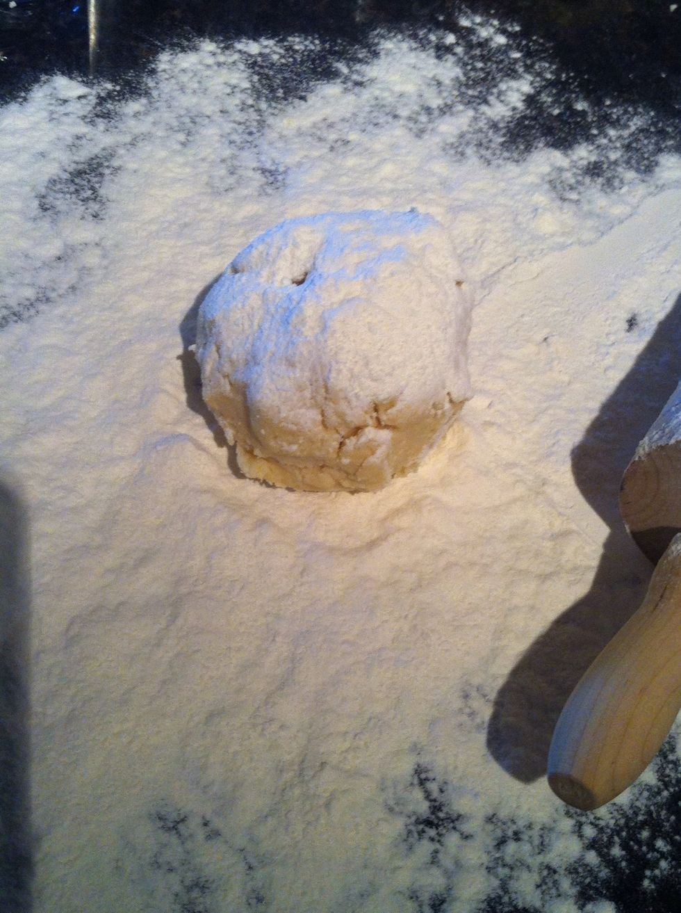Take one half of the dough and put in the middle of your flour covered surface.