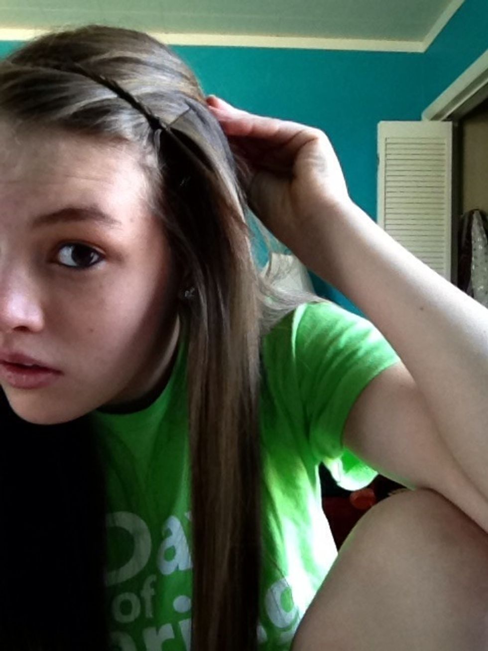 Take one of the braids and bring it to the opposite side. Use a bobby pin to keep it in place.