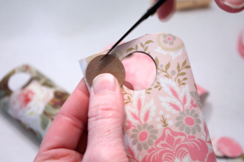 take one of the chads and use it as a guide to trim the corners off each side- you can make a pencil line if you want