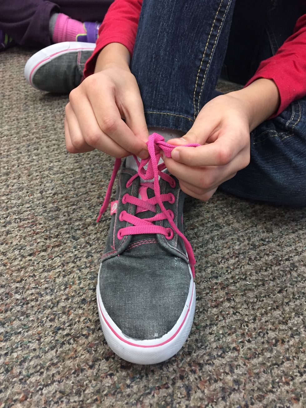 Take one of the loops and tuck it through the hole.