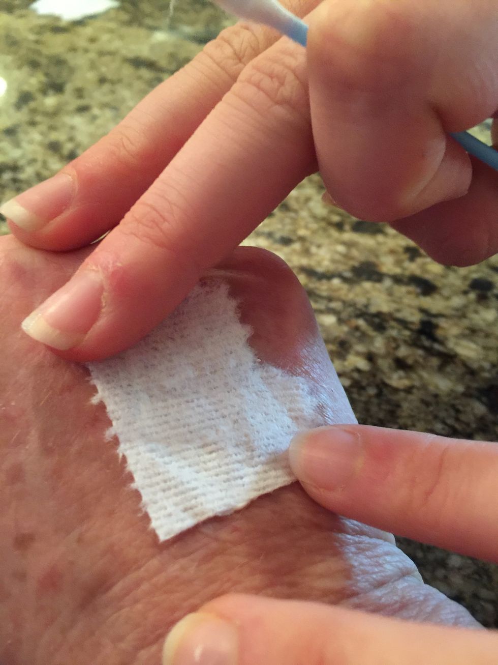 Take one of the pieces of toilet paper, and flatten it over the liquid latex.