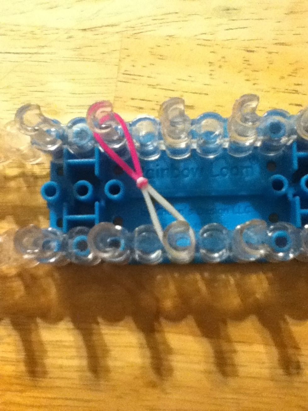 Take one of the set of bands and place them where ever towards the middle of loom in this position.