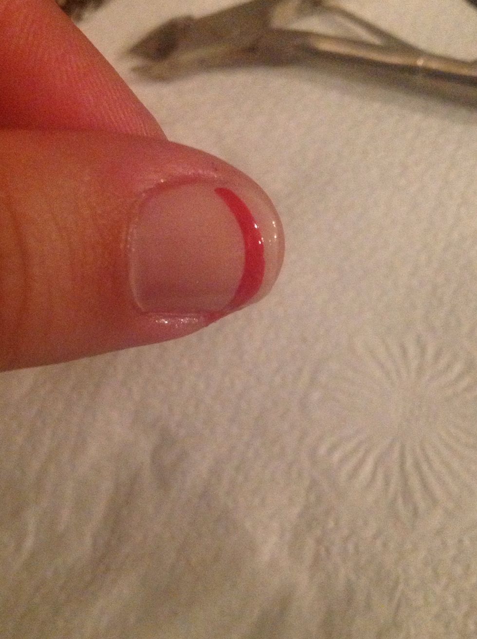 Take one of your selected colors & instead of at the very edge of the nail, apply a curved line right below where you would normally apply the white polish. Take your time & go very slow.