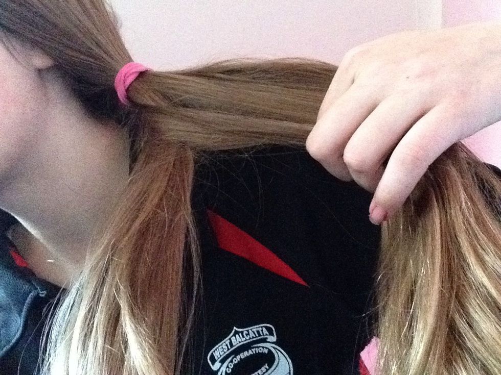 Take one thin strip of hair from the left side and take it over to the other side then hold the hair firmly.