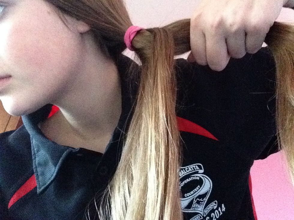 Take one thin strip of hair from the right side and take it over to the other side then hold the hair firmly.