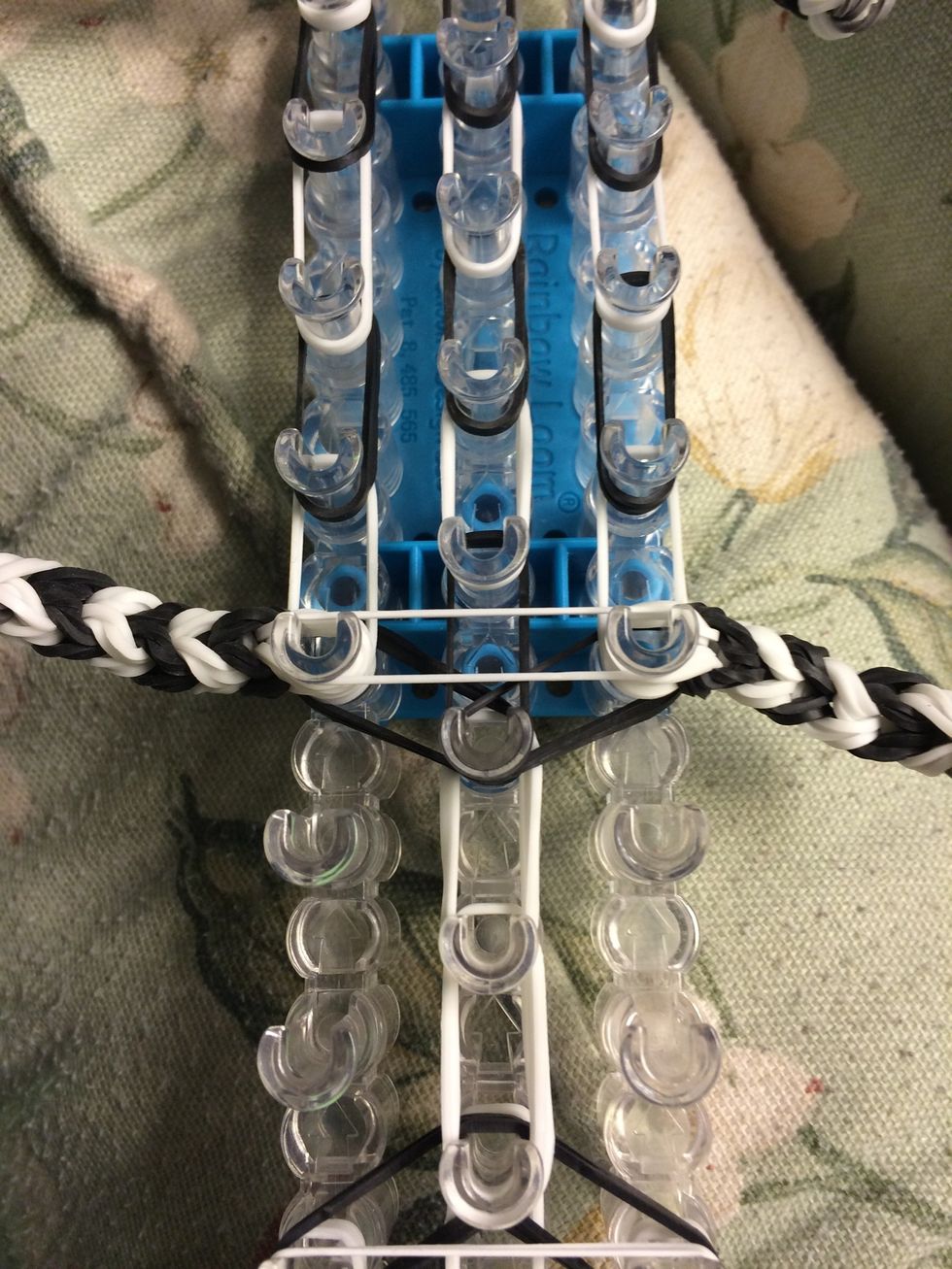 Take one white band and place it across the legs