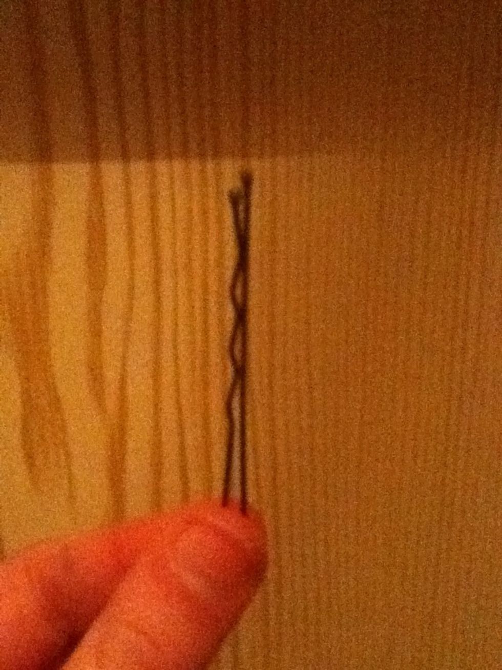 Take out a bobby pin it does not necessarily have to match the hair colour as it is going to be completely out of sight