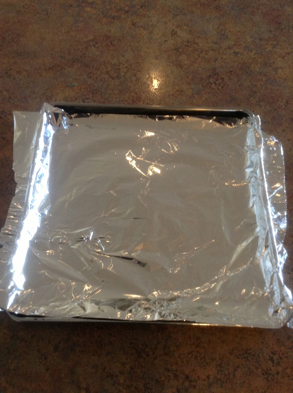 Take out baking sheet. Then line it with aluminum foil.