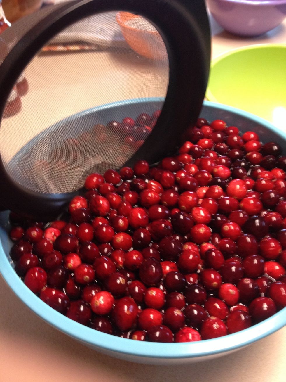 Take out cranberries out with a sieve.  DO NOT pour this through the sieve, that will just put all of the dirt back into the cranberries!!