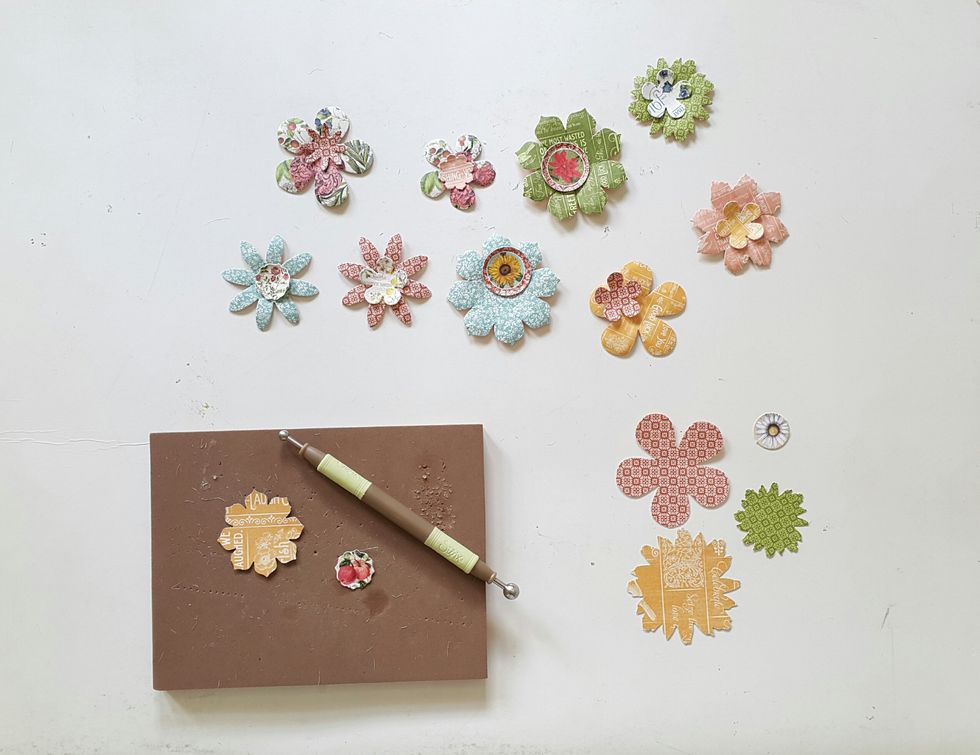 Take out flower die-cuts from the Graphic 45 Time to Flourish Flowers pack and curve them into shape with ball tool