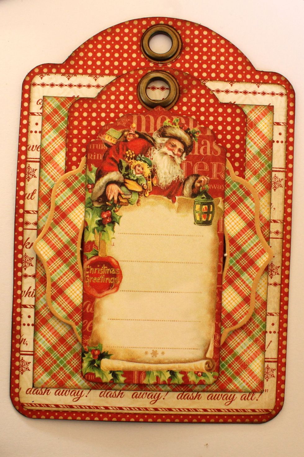 Take out one of the die-cuts from the Tags & Pockets packaging and attach it on top of the chipboard frame.
