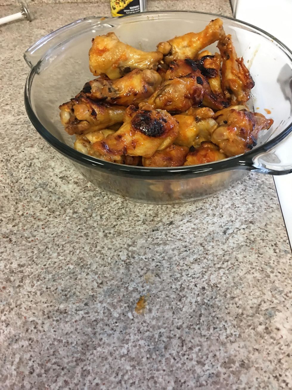 Take out the cooked chicken wings. Place them within a bowl and add sauce mixture, and mix.