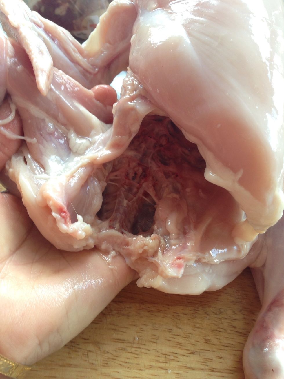 Take out the guts from inside the backbone (red stuff). Reason I take it out is because if you are going to keep the chicken for more than a day, it will not smell.