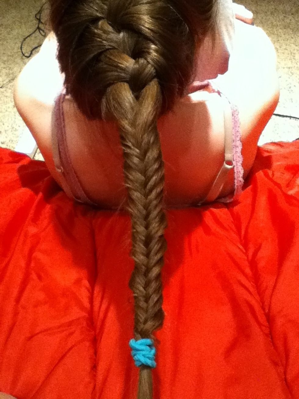Take out the hair tie that separates the French braid and the fishtail braid.