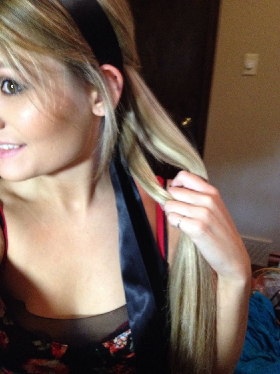 Take out the pony and divide your hair in two pieces add in the ribbon to have three pieces for braiding.