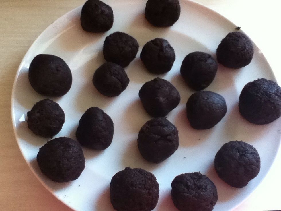 Take out toothpicks - and dip the end of them into the melted chocolate, and then put them into the balls. Then dip the balls into the melted chocolate, then sprinkle Sprinkles' onto them :)
