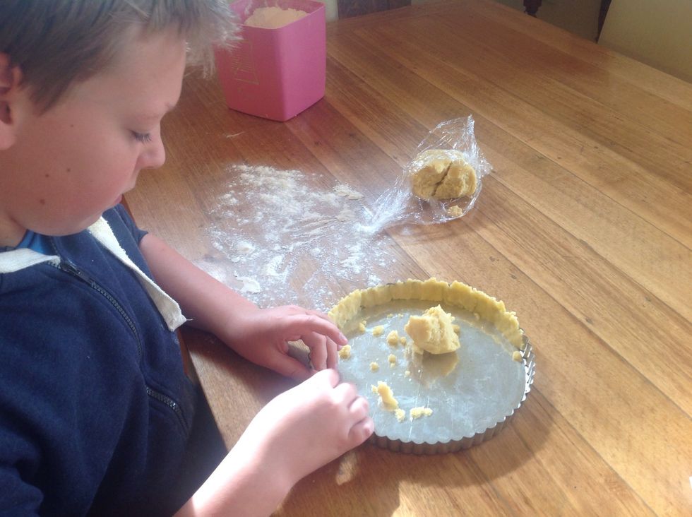 Take pastry out of the freezer then start to press the pastry around the case